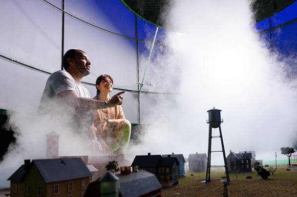 Two researchers work in the tornado simulator.