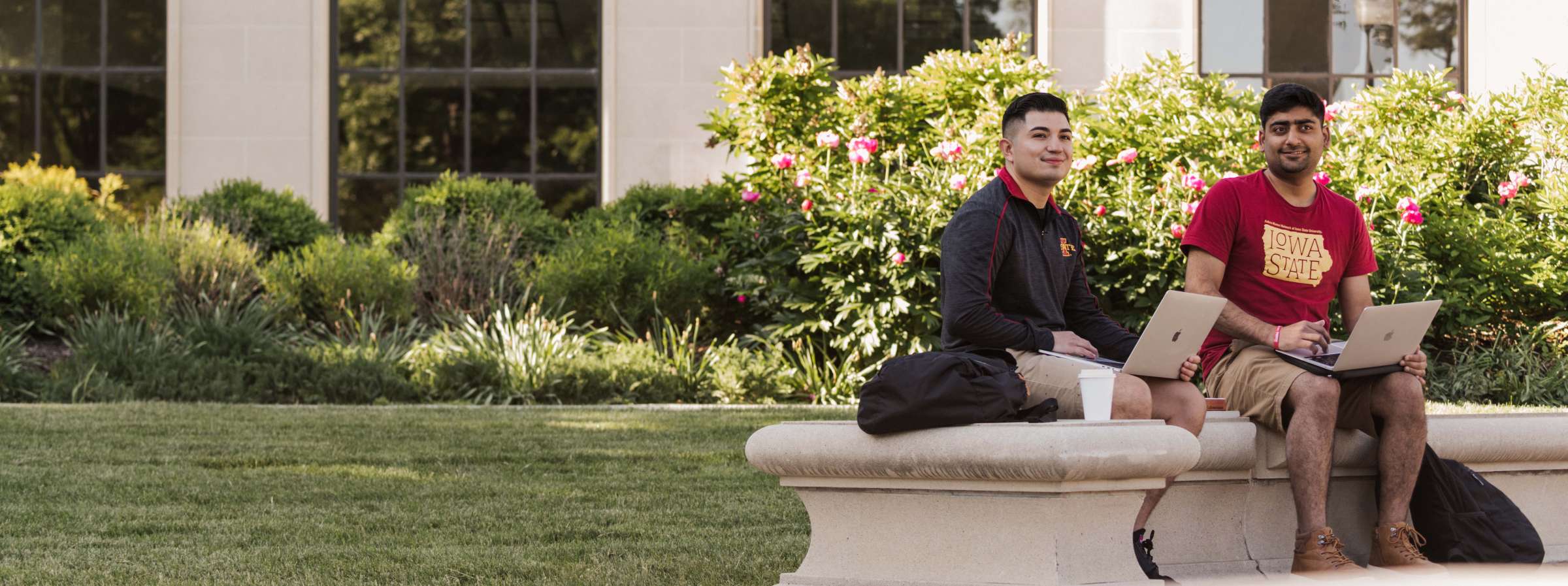 Two students sit in front of the Memorial Union