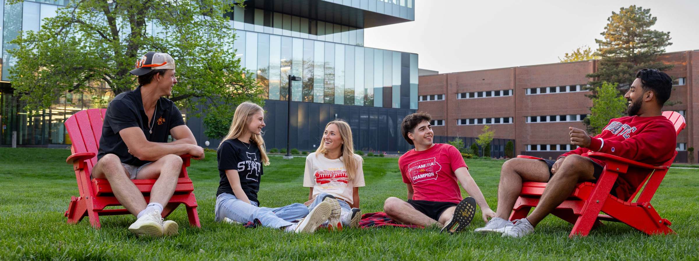 Five students sitting outside the Student Innovation Center